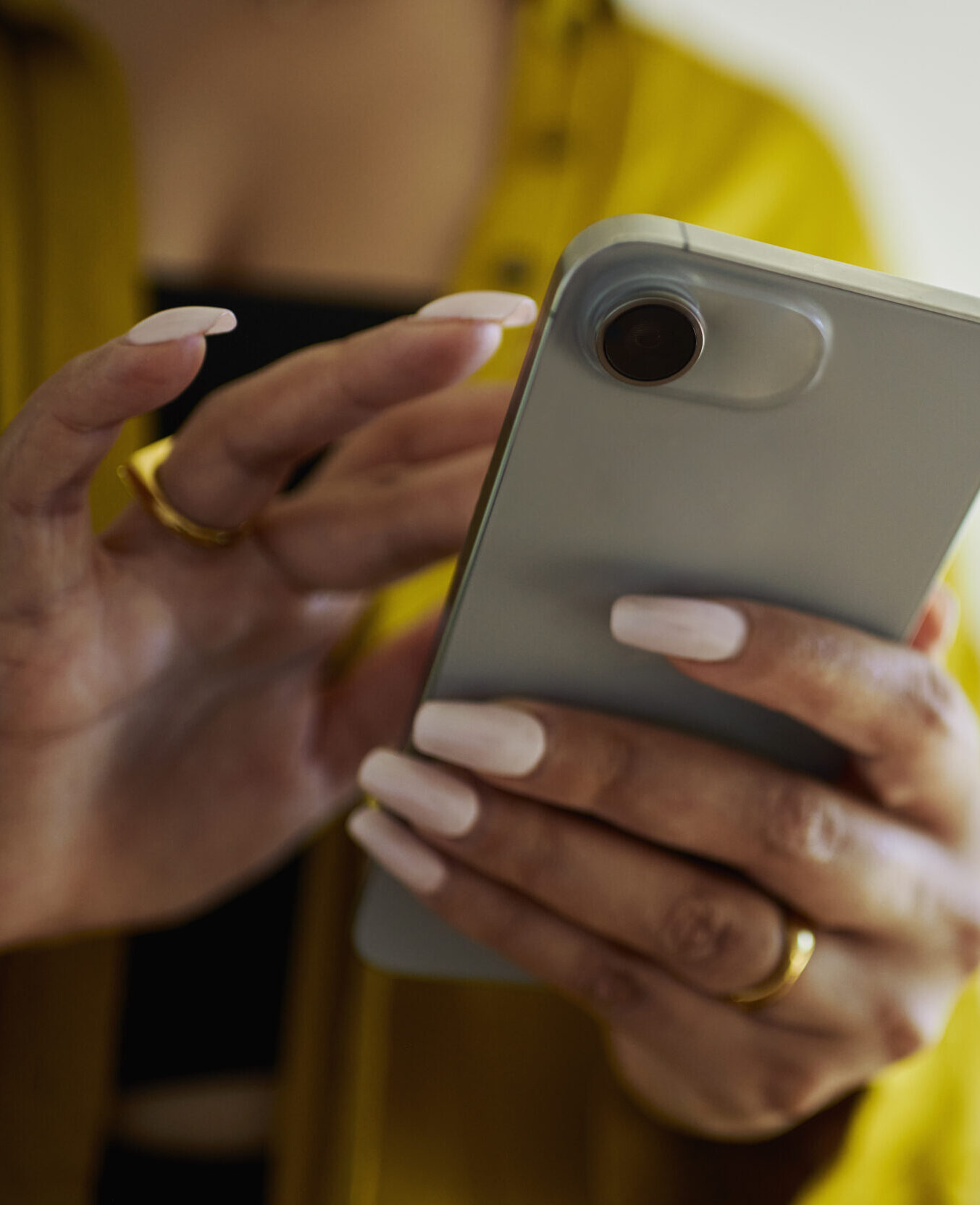 Close-up shot capturing a woman's hands as she types and texts on her mobile phone, staying connected and engaged with modern technology.